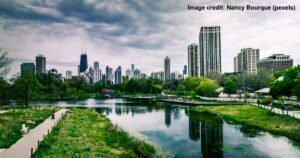 River Near City Buildings Under Cloudy Sky