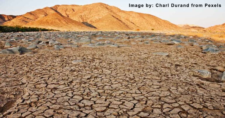 Desert Area with Cracked Ground and Mountain